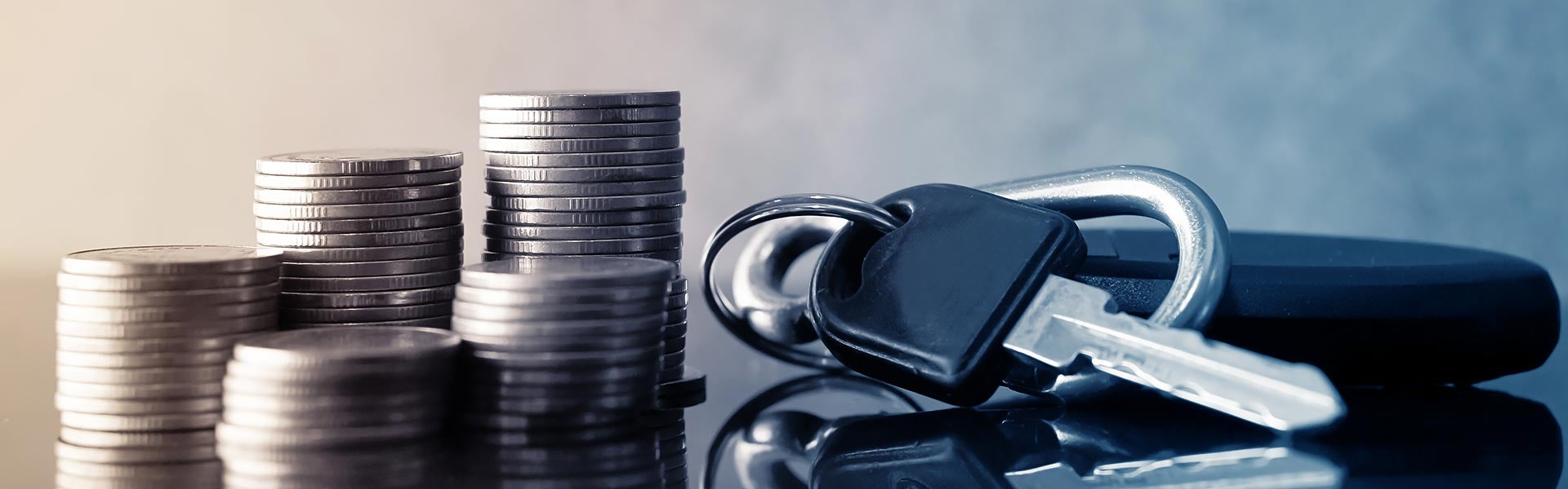 Stacks of coins next to a car key fob